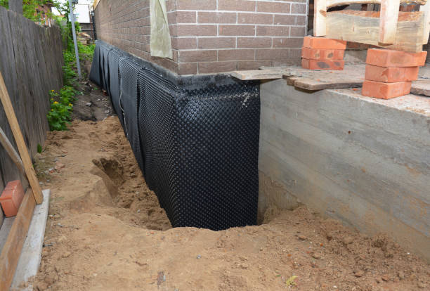 Happy homeowners after waterproofing job in Okeana